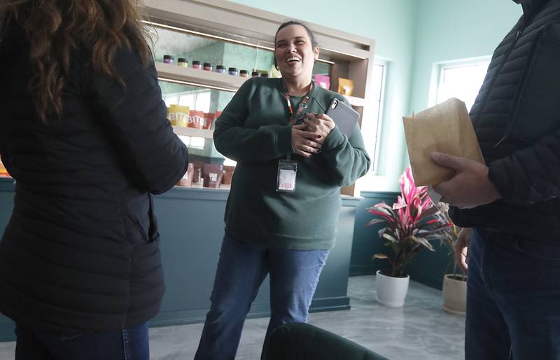Bud-tender Meredith Nichols talks with people during an open house Thursday, Feb. 2, 2023, at the Ivy Hall Crystal Lake, a social equity-licensed cannabis dispensary that recently opened at 501 Pingree Road in Crystal Lake.
