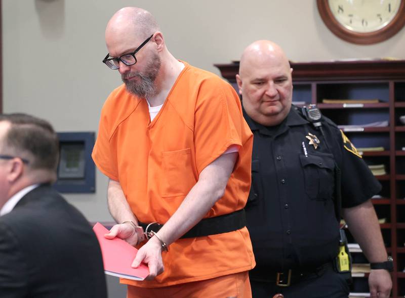 Jonathan Hurst is escorted by a DeKalb County Sheriff’s Deputy into Judge Marcy Buick’s courtroom at the DeKalb County Courthouse in Sycamore Monday, April 29, 2024 for a hearing on his case. Hurst is charged with murder in the August 2016 slayings of mother and son, Patricia A. Wilson, 85 and Robert J. Wilson, 64, of Sycamore.