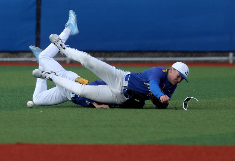 Johnsburg's Brady Fisher Lakes'John Zutkis and Johnsburg's Jacob Smith hit the ground after going after the ball during a Kishwaukee River Conference baseball game against Richmond-Burton on Monday, April 6,2026, at Johnsburg High School.