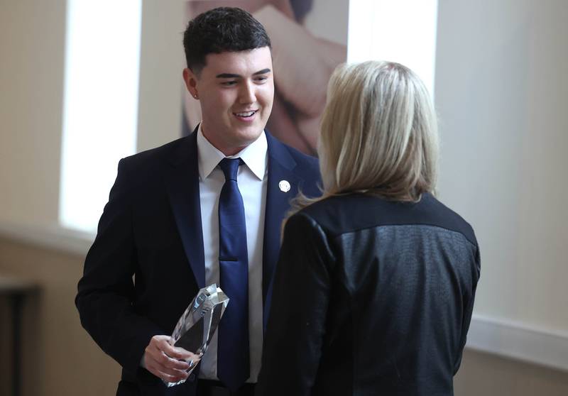 Andrew Miller, branch manager at Old National Bank, accepts the Outstanding Business Award on behalf of the bank Thursday, March 5, 2026, during the Sycamore Chamber of Commerce Annual Meeting in Memorial Hall at St. Mary's Catholic Church in Sycamore.