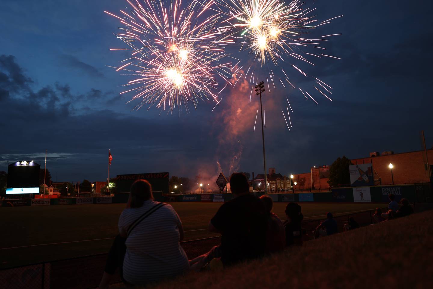Fans sit in the lawn section to watch the fireworks on the Joliet Slammers Military Appreciation night on Saturday, July 1st, 2023, in Joliet.