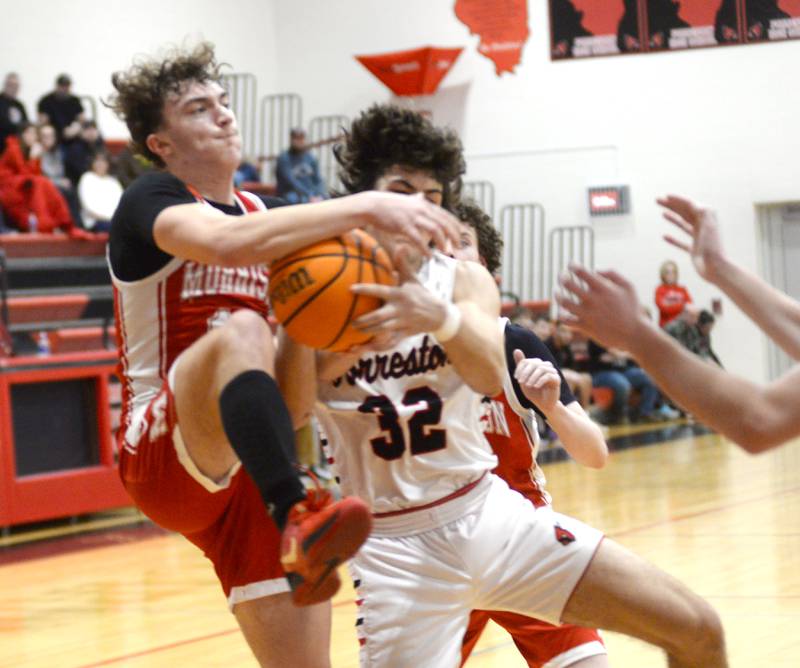 Morrison's Colton Bielema (10 ) and Forreston's Jonathan Milnes (32) fight for the ball during Saturday, Feb. 8, 2025 action at Forreston High School. The Cardinals won the game 70-49.
