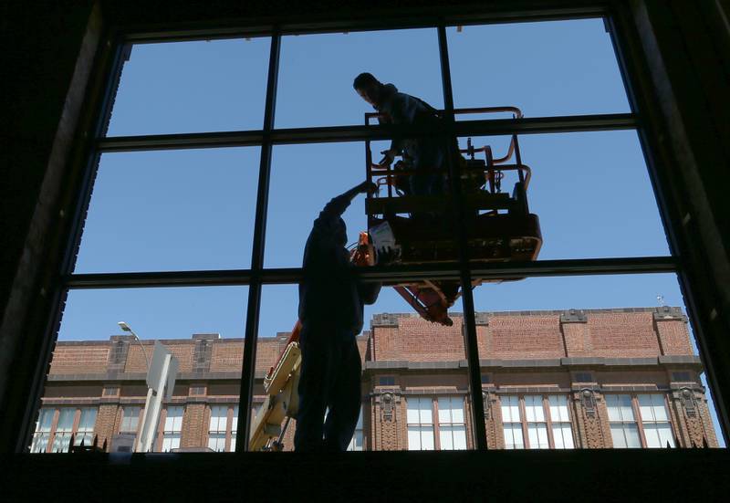 Workers with the Westclox building, install a new window on the exterior of the building on Tuesday, April 21, 2022 in Peru. The next phase of the building will include a 8,000 square foot renovation of a event center. Work includes replacing seven large iconic windows, new floors and electrical. The new event center will occupy the space next to the recent Fire on Fifth restaurant. Banquets, weddings and other occasions will available to clients. This is the largest renovation to the building. Completion is scheduled to be finished by mid-September.