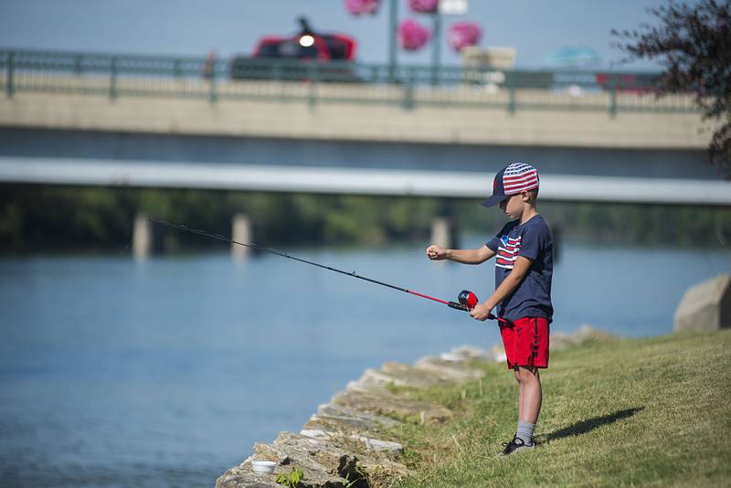 Drew Melendez, 8, of Dixon works to untangle a line during the fishing derby Saturday, July 2, 2022.