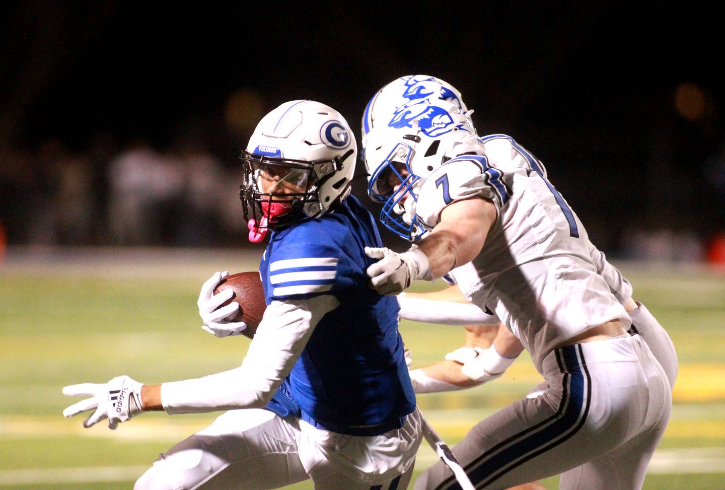 Geneva’s Talyn Taylor carries the ball under St. Charles North’s Gunnar Tosaw on Friday, Oct. 25, 2024 during a game at Geneva.