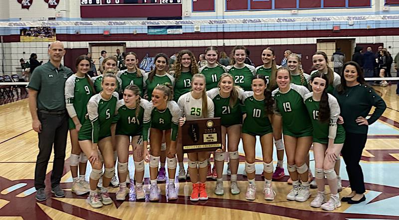 The Providence Catholic girls volleyball team shows off its plaque after winning the Class 3A Kankakee Sectional championship Thursday.