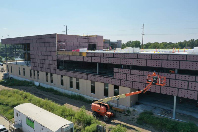 Workers use a lift to work on the exterior of the YMCA building on Monday, Aug. 28, 2023 in Ottawa. The new $25.7 million facility expected to be completed in the spring of 2024.