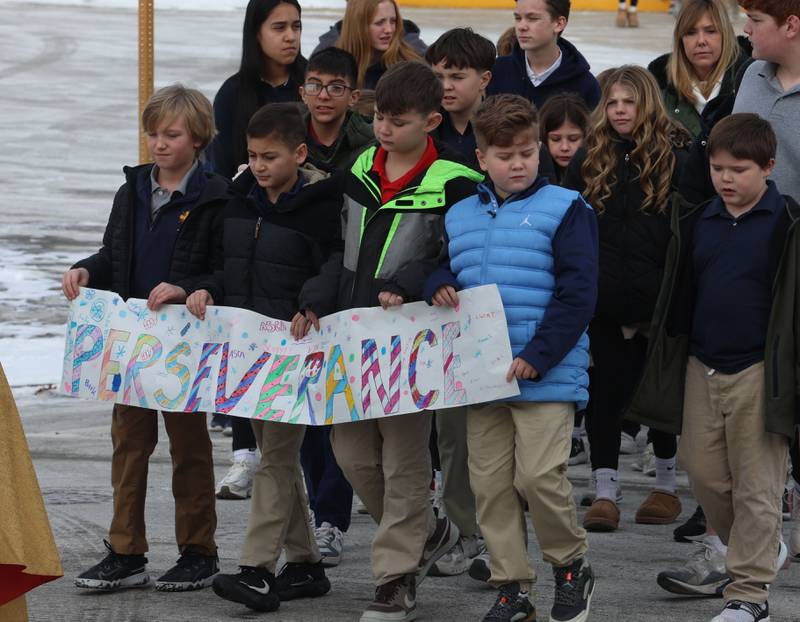 Students from Academy of St. Carlo Acutis hold a banner that reads "Perseverance" as they walk during a Eucharistic Procession to St. Joseph’s Catholic Church on Friday, Jan. 30, 2026 in Peru. Over 350 students and staff from Academy of St. Carlo Acutis celebrated the very first all-school Mass.