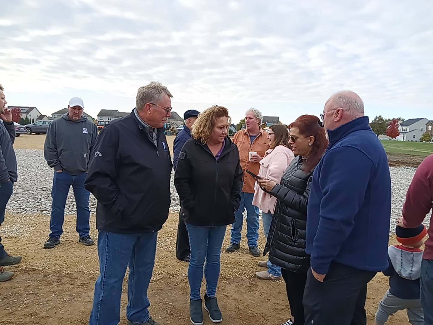 Elburn Village President Jeff Walter (left) and his wife Carrie chat with attendees at a groundbreaking ceremony Nov. 1, 2025, for the newest section of Blackberry Creek development.