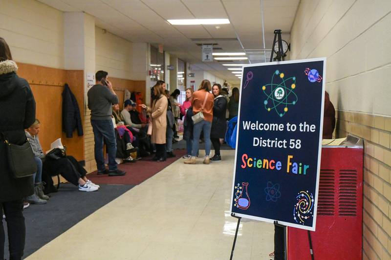 Family’s wait in the hallways of O’Neill Middle School in Downers Grove during the District 58 science fair held on Saturday Jan. 20, 204.Family’s wait in the hallways of O’Neill Middle School in Downers Grove during the District 58 science fair held on Saturday Jan. 20, 204.