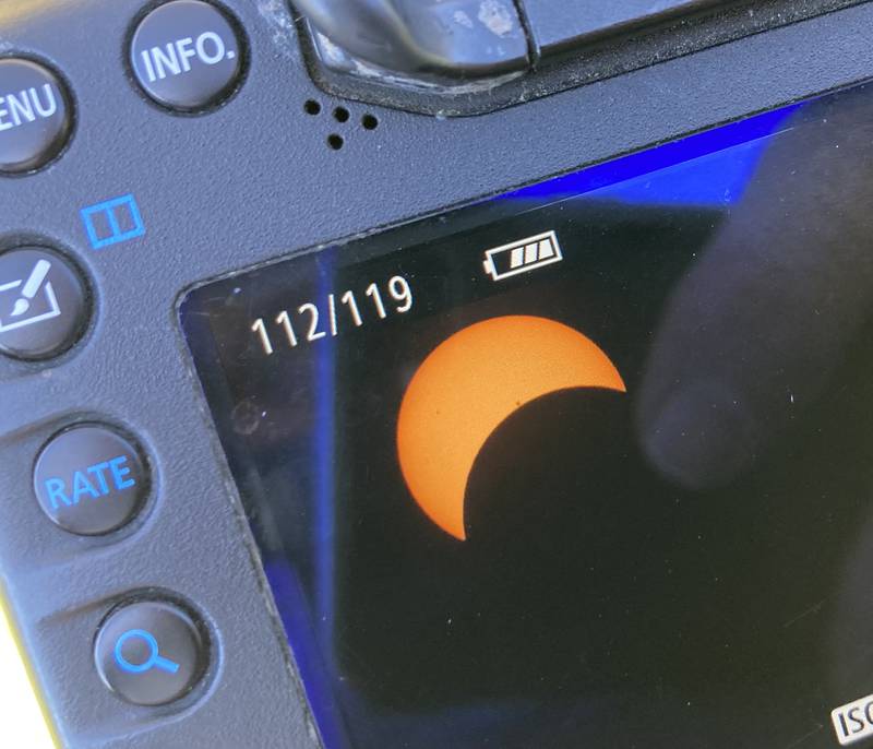 An image of the solar eclipse as the moon moves into the line of sight of the sun is shown on a camera screen in Crystal Lake on April 8, 2024.