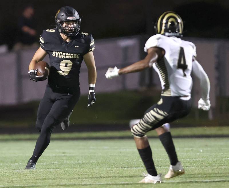 Sycamore's Dawson Alexander looks to get by Oak Forest's Anthony Pickens during their game Friday Sept. 2, 2022, at Sycamore High School.