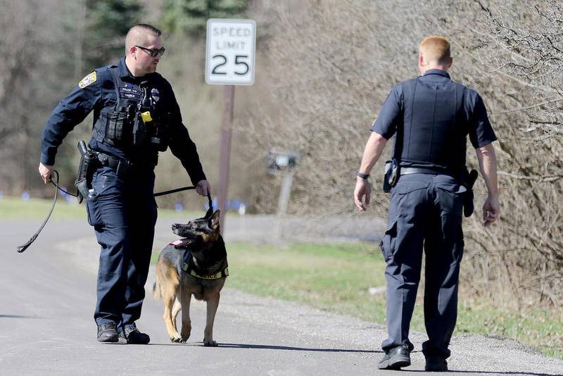 Law enforcement investigate the area around Joy Lane surrounding the scene of an alleged two-person stabbing, home invasion and sexual assault on Monday in Sleepy Hollow.