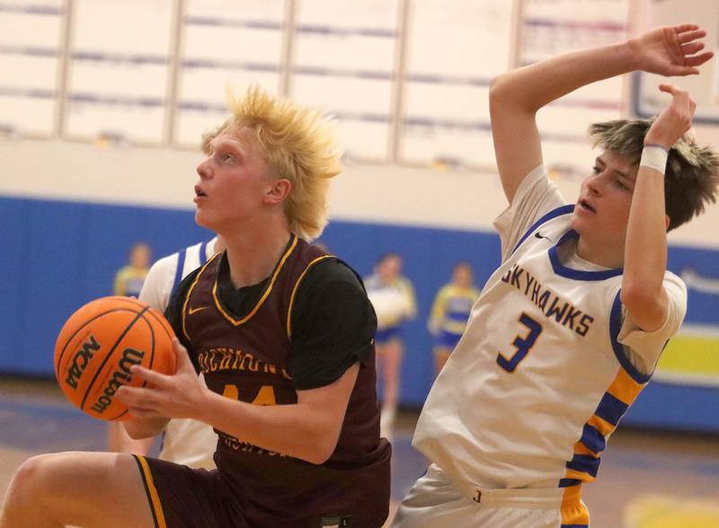 Richmond-Burton’s Ray Hannemann, left, gets past Johnsburg’s Trey Toussaint in varsity boys basketball onTuesday, Dec. 9, 2025, at Johnsburg High School in Johnsburg.