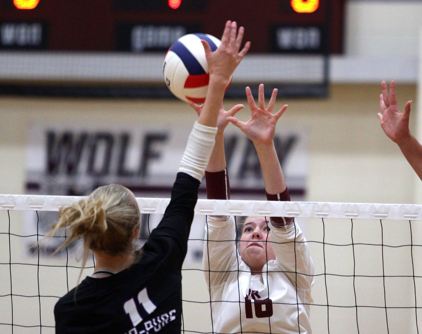 Prairie Ridge’s  Adeline Grider blocks against Hampshire during varsity volleyball on Thursday, Oct. 3, 2024, at Prairie Ridge High School in Crystal Lake.