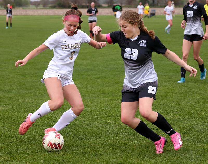 Sycamore's Marin Gautcher (left) and Kaneland's Lindsey Stoddard battle for possession Wednesday, April 30, 2025, during their game at Kaneland High School in Maple Park.