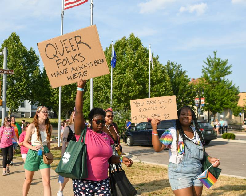 Shakerra Phinisee, left, of Mississippi and Dashay Ganer of Chicago hold up signs during the annual DeKalb Pride Fest held in downtown DeKalb on Thursday June 22, 2023.