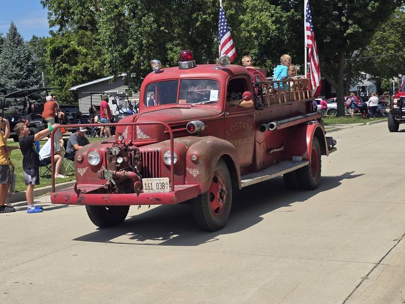 An old Lostant fire truck rides through the Wenona Days Grand Parade on Sunday, Aug. 11, 2024.