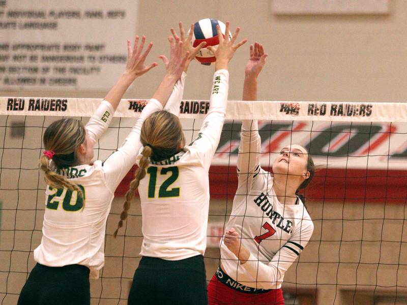Huntley’s Jocelyn Erling, right, sends the ball over the net as Crystal Lake South’s Morgan Johnson (20) and Joanna Kruzolek (12) defend in varsity volleyball at Huntley Tuesday.