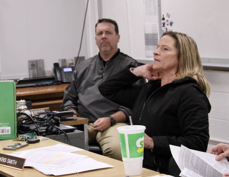 Principal Michael Berentes listens as Interim Assistant Principal Kristina Smith makes a presentation on the revisions being made to the student handbook during a meeting Wednesday of the Rock Falls High School board of education.