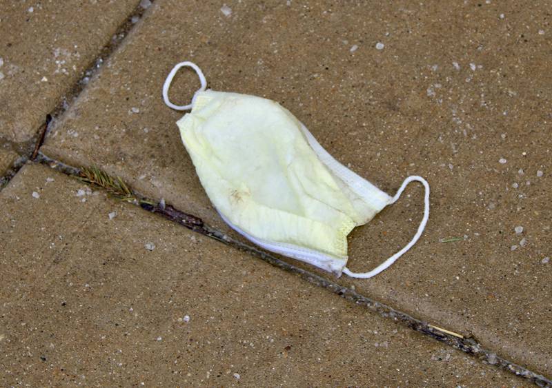 A face mask lays discarded Wednesday on the sidewalk outside Town Square Centre on First Street in Dixon, the same day that Gov. JB Pritzker announced he would provisionally lift the masking mandate for the state on Feb. 28.