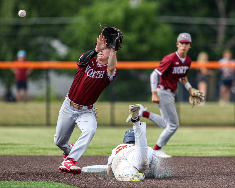 Oswego's Cade Duffin (23) slides into second while Plainfield North's Tyler Evans (4) takes the throw during Class 4A Romeoville Sectional semifinal game between Plainfield North at Oswego.  June 1, 2023.