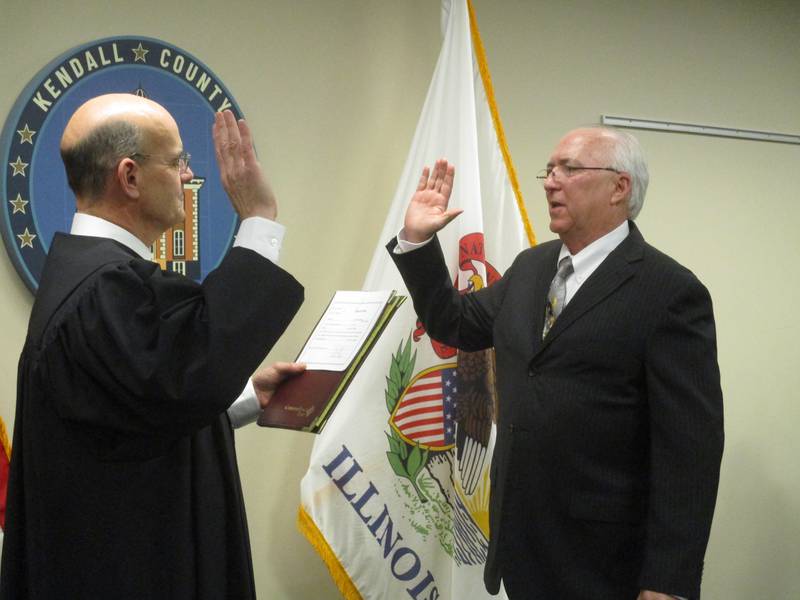 Kendall County Board member Brian DeBolt takes the oath of office from Judge Stephen Krentz on Dec. 5, 2022. DeBolt was subsequently elected by his peers as president of the Kendall County Forest Preserve District.