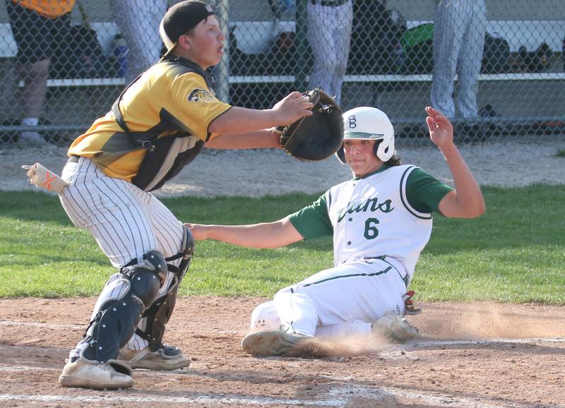 St. Bede's Nathan Husser slides safely into home plate as Putnam County's Traxton Mattingly waits for the throw on Tuesday, April 30, 2024 at St. Bede Academy.