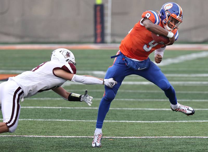 East St. Louis' Robert "Pops" Battle pulls away from Prairie Ridge's Zander Severson during their IHSA Class 6A state championship game Saturday, Nov. 26, 2022, in Memorial Stadium at the University of Illinois in Champaign.