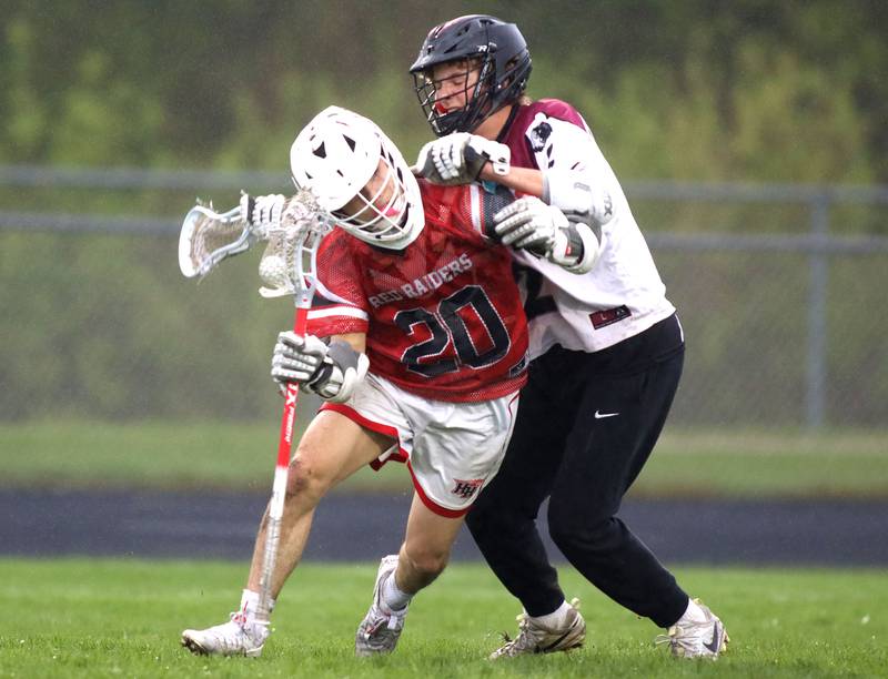 Huntley’s Cameron Abordo, front, battles past a Prairie Ridge defender in varsity boys lacrosse at Prairie Ridge  High School in Crystal Lake on Thursday, May 1, 2025.
