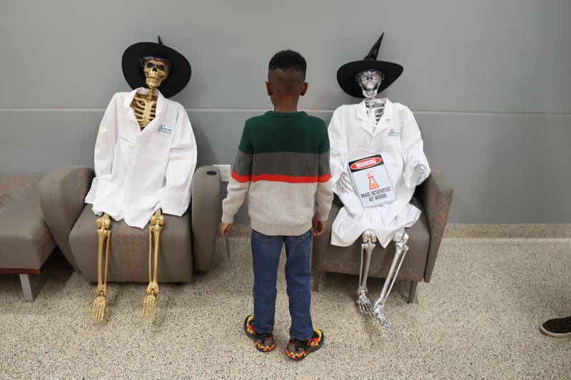 A child checks out the skeletons in the hallways of Lewis University at the STEAM Spooktacular hosted by the After the Peanut Foundation on Wednesday.