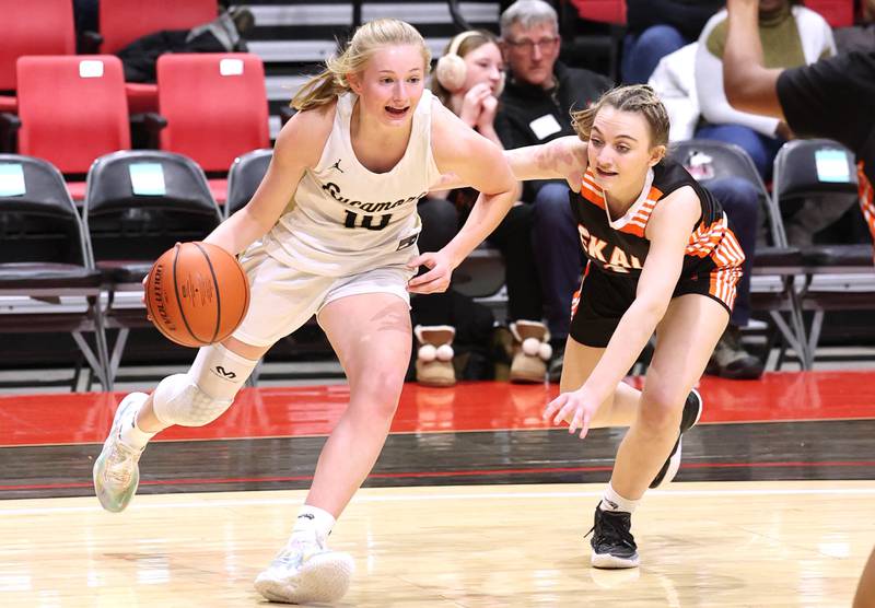 Sycamore's Lexi Carlsen drives baseline against DeKalb's Ella Russell during the First National Challenge Friday, Jan. 27, 2023, at The Convocation Center on the campus of Northern Illinois University in DeKalb.