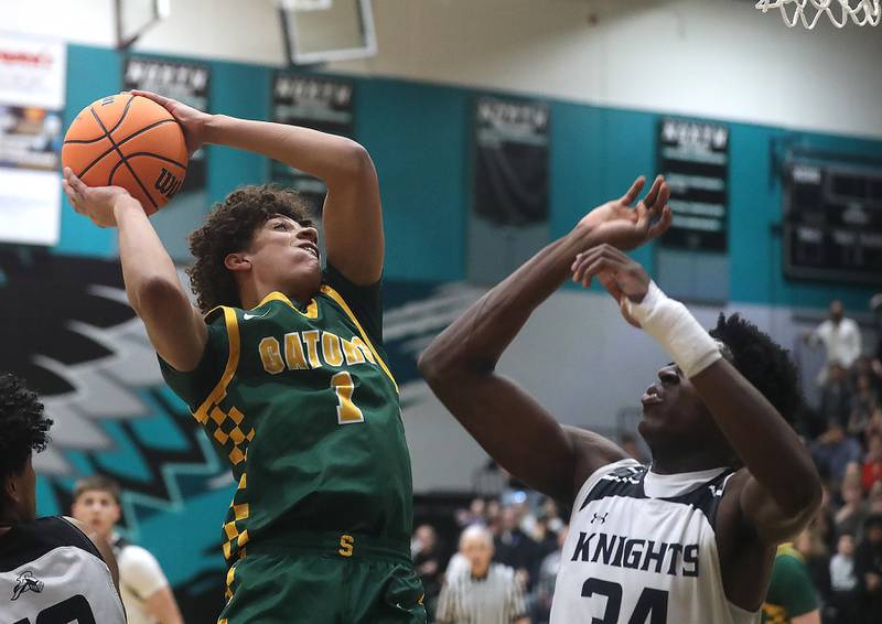 Crystal Lake South's Noah Cook shoots the ball over Kaneland’s Jeffery Hassan during the IHSA Class 3A Woodstock North Sectional final basketball game on Friday, March 6, 2026, at Woodstock North High School.