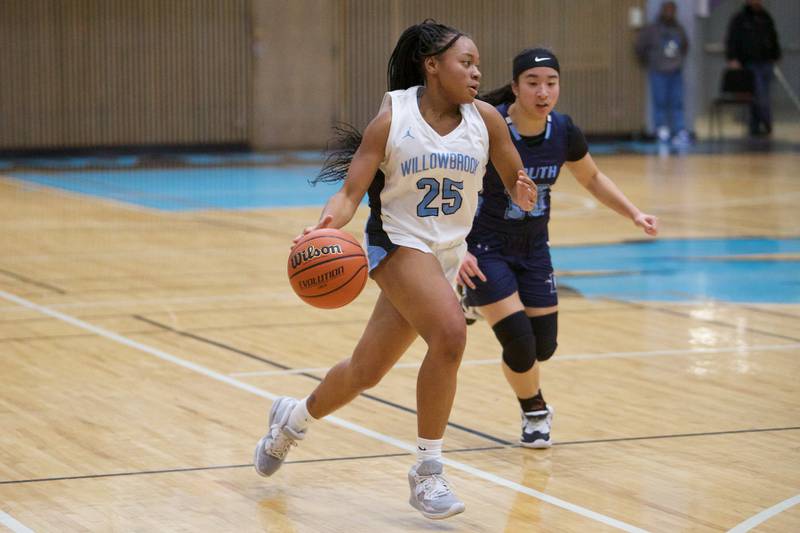 Willowbrook's Tia Kelly drives the ball up court past Downers Grove South's ElizabethRous on Friday, Feb.3,2023 in Villa Park.
