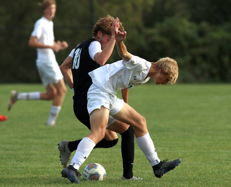 Crystal Lake South’s  Dustin Banner battles Prairie Ridge’s Chase Santucci, back, in varsity soccer on Thursday, Sept. 19, 2024, at Prairie Ridge High School in Crystal Lake.