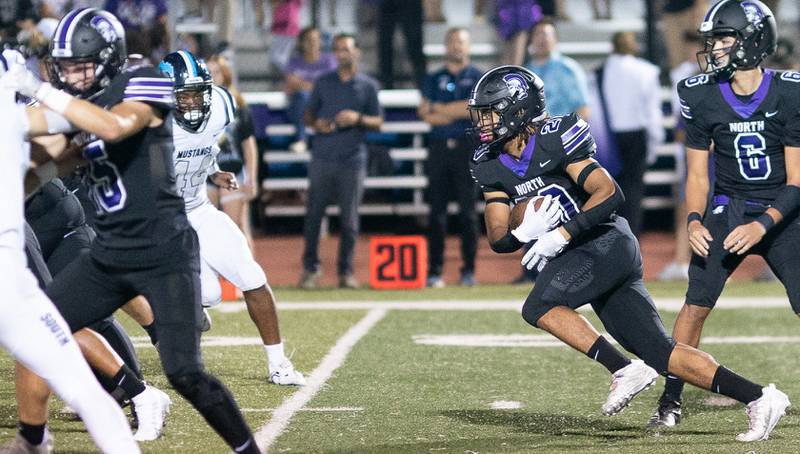 Downers Grove North's Noah Battle (20) carries the ball against Downers Grove South during a football game at Downers Grove North High School on Friday, Sep 9, 2022.