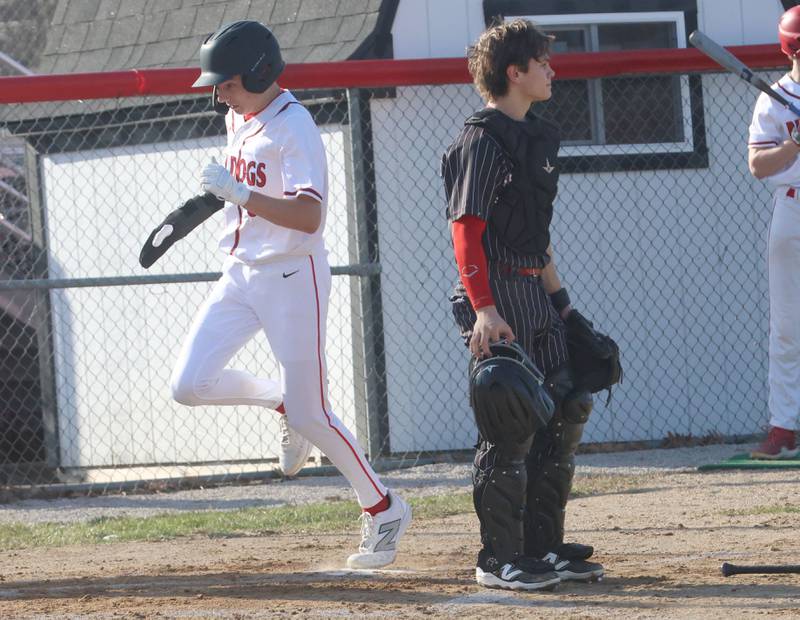 Maddan McCloskey crosses home plate as Hall catcher Greyson Bickett watches the play on Thursday, March 19, 2026 at Streator High School.