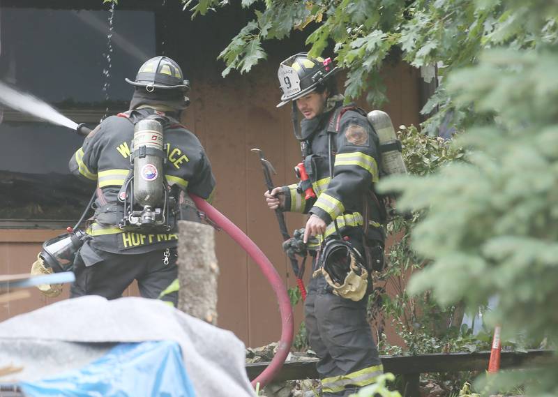 Wallace firefighters Ben Hoffman and Ben Herzog work the scene of a fully-engulfed structure fire in the 500 block of North 2782nd Road on Monday, July 21, 2025 in La Salle. FIre departments from Utica, Wallace, Naplate, Spring Valley, Mendota, Troy Grove, La Salle, Peru, Oglesby and Tonica responded to the scene. Fire crews were dispatched at 9:45 a.m. La Salle Police and La Salle County Sheriff were also on the scene.