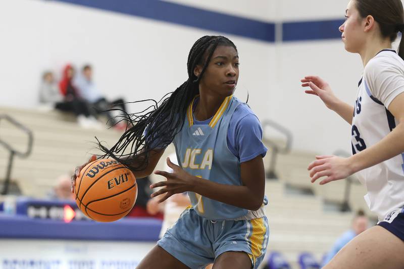 Joliet Catholic’s Makenzie Keltz looks for a play against Reavis in the Peotone Blue Devils Holiday Classic championship game on Monday, Dec. 29, 2025 in Peotone.