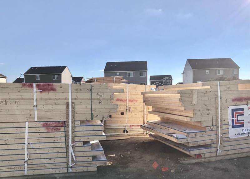 Lumber awaits homebuilders on a lot in Oswego's Ashcroft Subdivision.