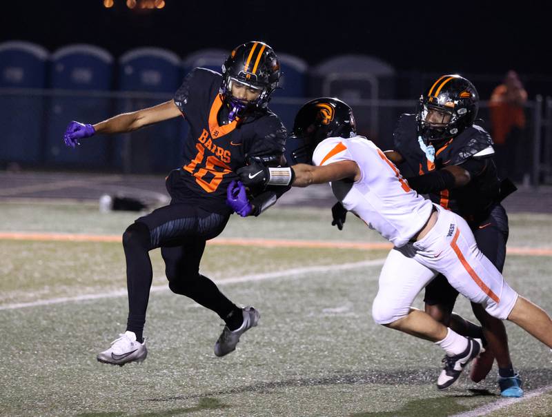 DeKalb's Braylen Anderson tries to avoid Lincoln-Way West's Maxwell White on a kick return during their game Friday, Oct. 3, 2025, at DeKalb High School.