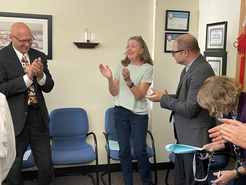 Bonnie Campbell, Associate Vice President for Academic Affairs, received a standing ovation at Thursday’s meeting. Campbell is retiring after 25 years in various roles at the college. She is flanked by presidential search consultant Dr. Jim Carlson, left, and Vice President for Student Services Mark Grzybowski, right.