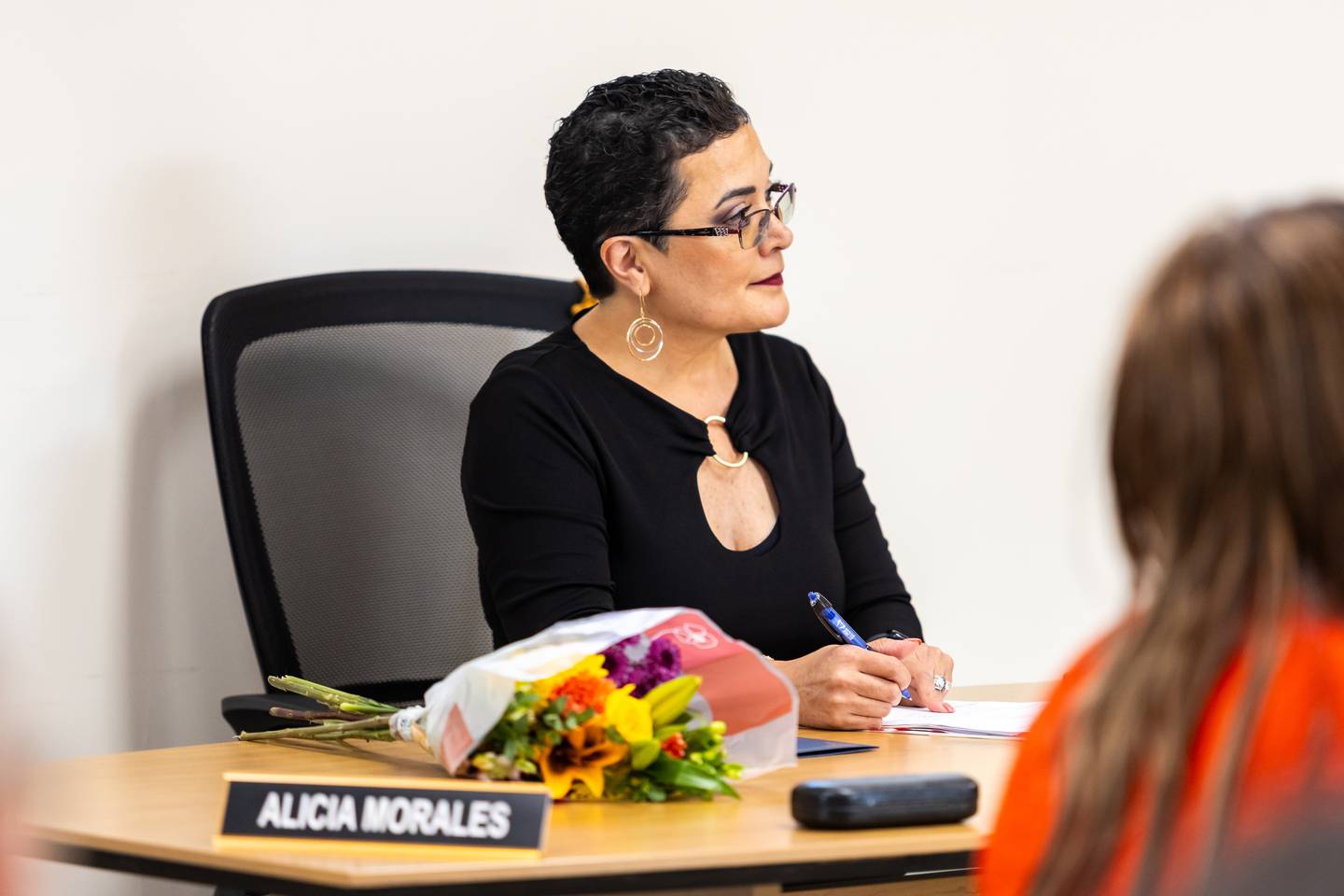 Joliet Township Clerk Alicia Morales follows along with the agenda during the special board meeting on July 16, 2024.