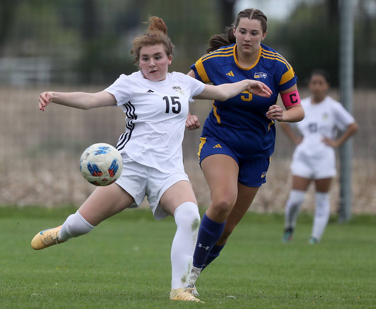Harvard's Lila Amis takes a shot on goal in front of Johnsburg's Elaina Moss during a Kishwaukee River Conference soccer match on Wednesday, April 27, 2026, at Johnsburg High School.