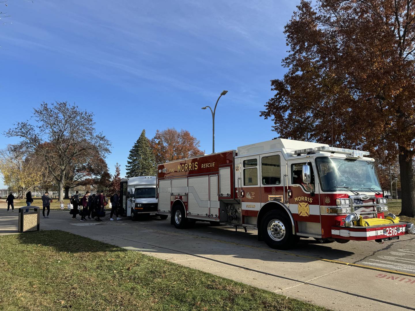 A firetruck waits to escort the Morris Community High School cross country runners as they head for the state level competition.