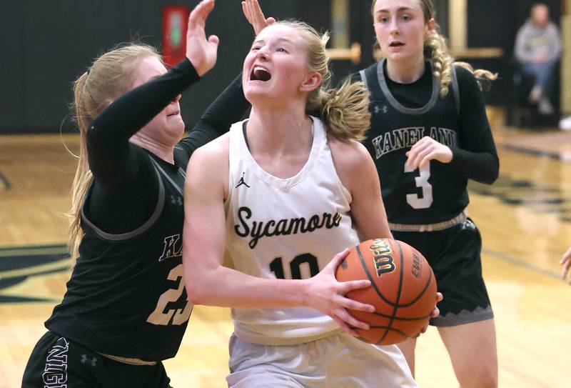 Sycamore's Lexi Carlsen goes to the basket against Kaneland's Kendra Brown during the Class 3A regional final game Friday, Feb. 17, 2023, at Sycamore High School.