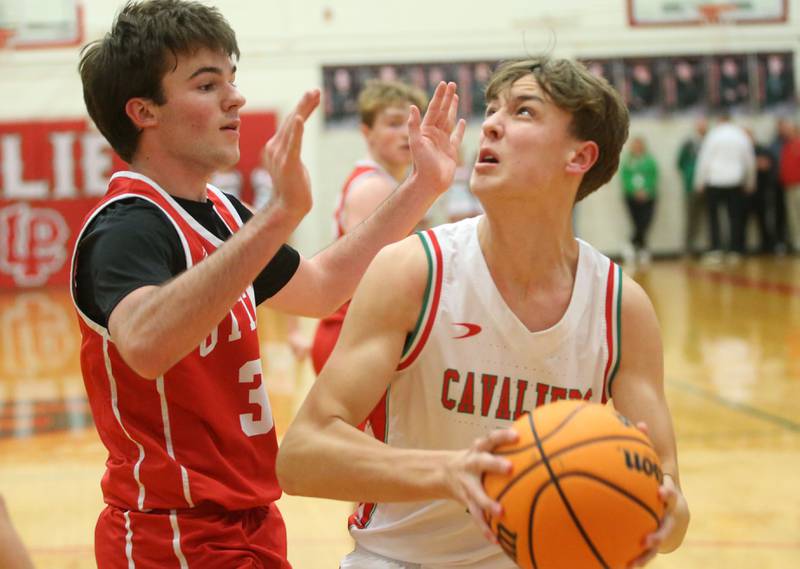 L-P's Jameson Hill drives in the lane as Ottawa's Seth Cooper defends on Friday, Feb. 7, 2025 in Sellett Gymnasium at L-P High School.