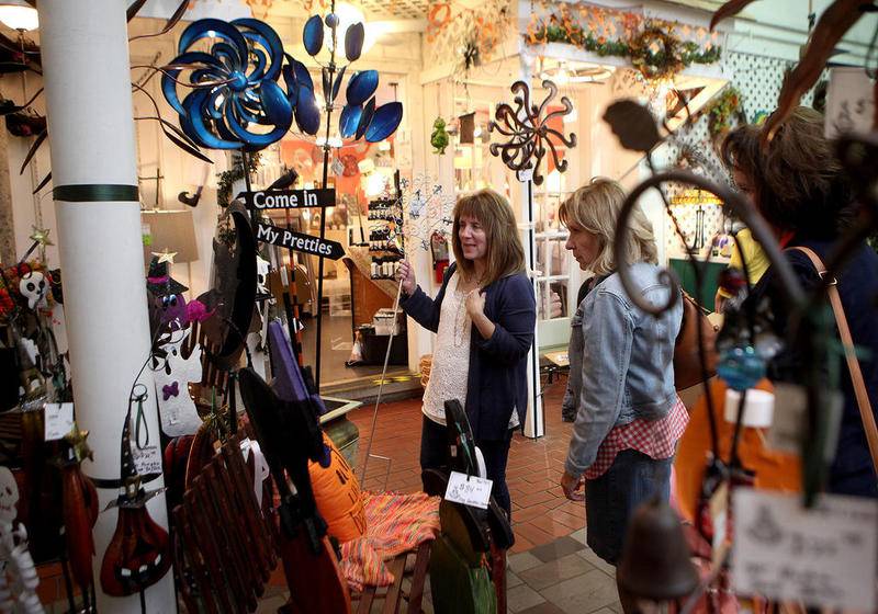 Sisters Lisa Rowley of Michigan (left) and Martha LaFave of Naperville (right) shop at The Little Traveler in downtown Geneva. The Little Traveler is 95 years old this year. A third sister, Becky Snyder of Peoria, was also part of the shopping day.