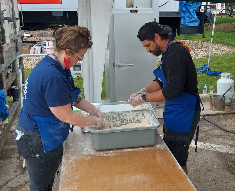 Rotary volunteers bread shrimp Saturday, June 1, 2024, during the ShrimpFest and Brew Hullaballoo at Rotary Park in Princeton.
