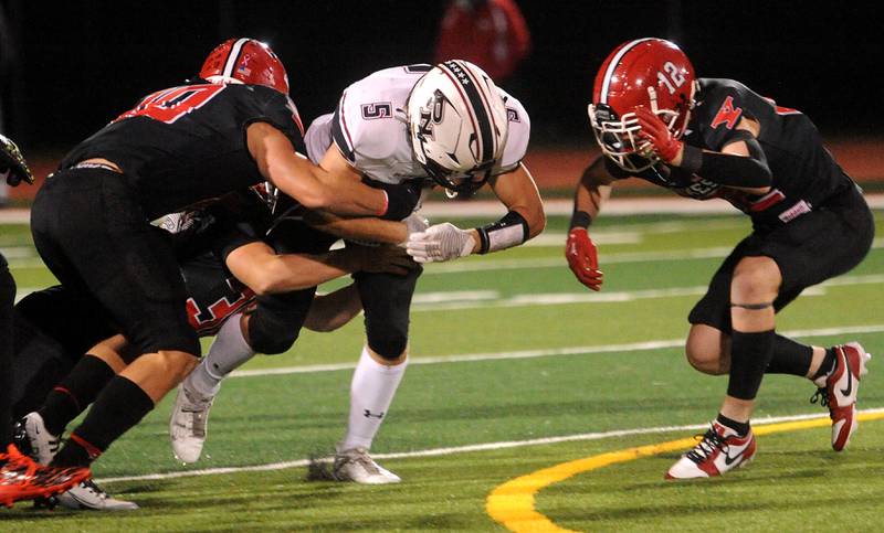 Plainfield North running back Robert Tota (5) finds a hole in the Yorkville defense during a varsity football game at Yorkville High School on Friday, Oct. 20, 2023.